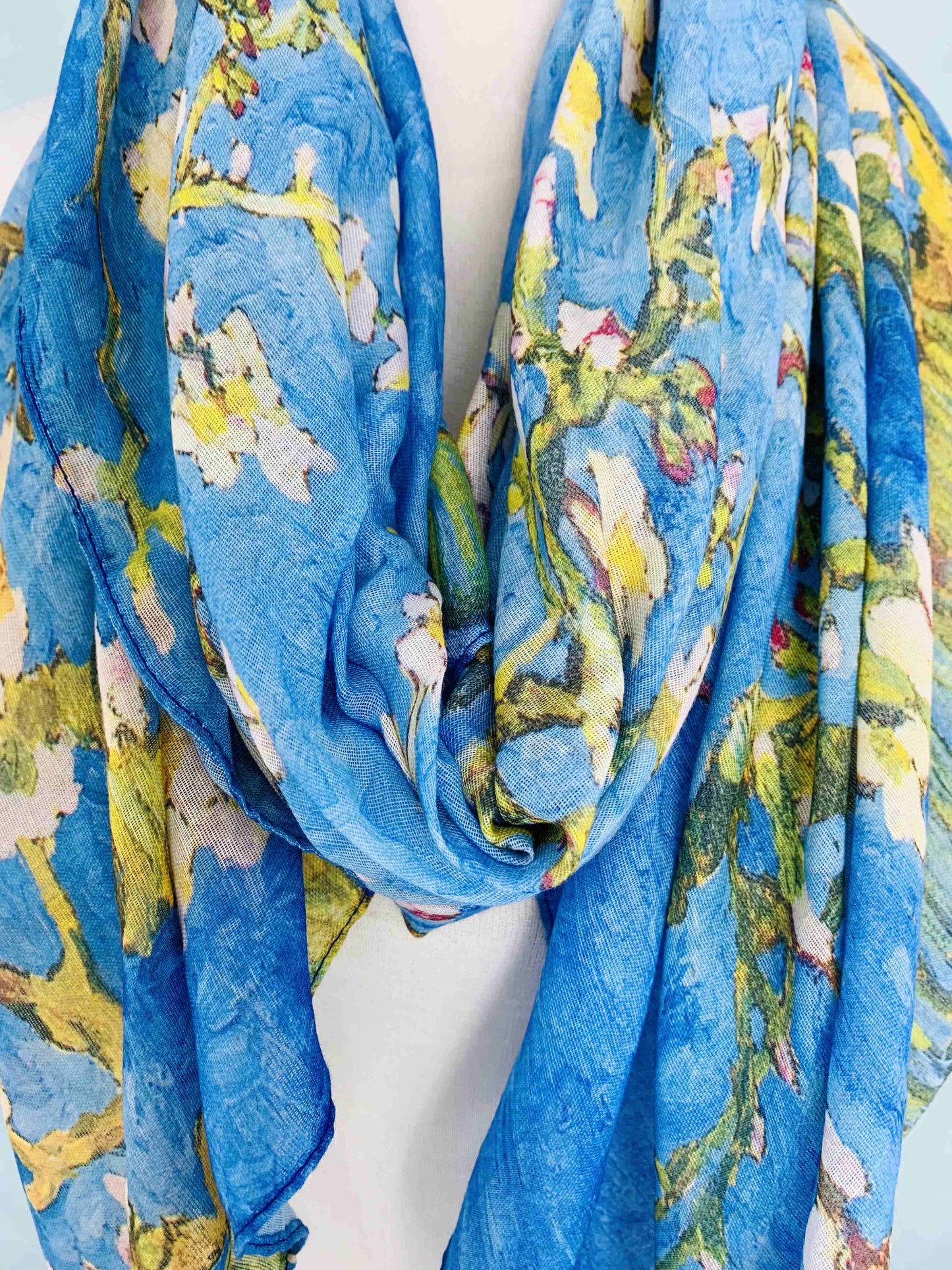 Blue floral patterned scarf on a white background
