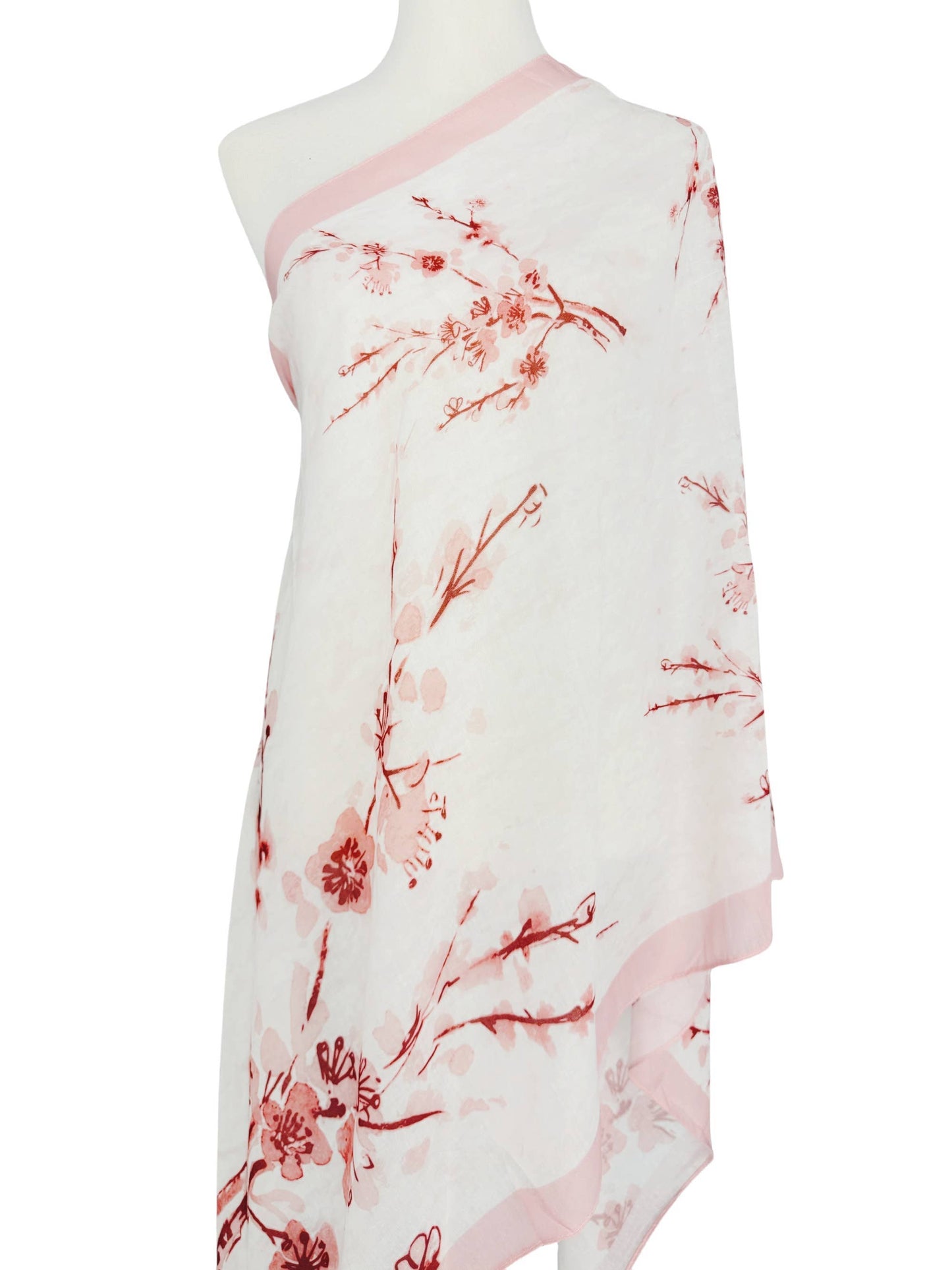 White dress with red floral pattern on a mannequin against a white background