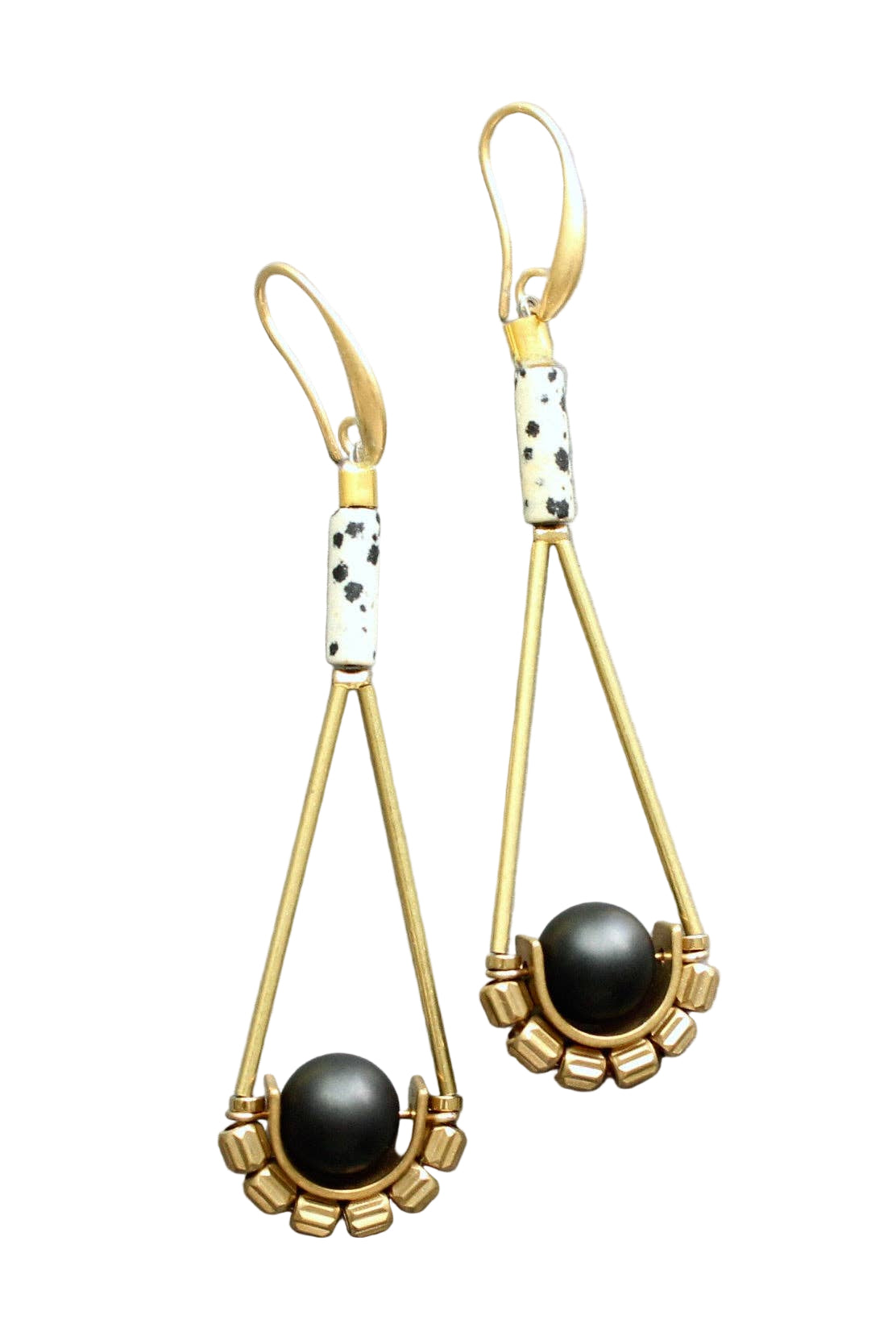 Gold earrings with black beads on a light gray background