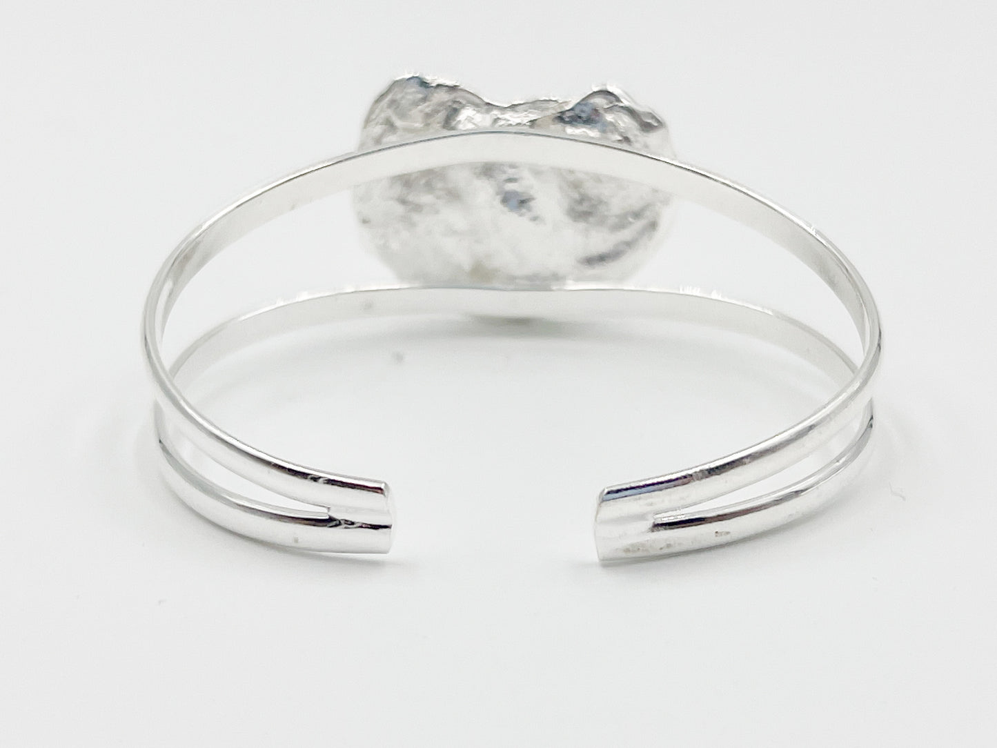 silver plated oyster bracelet on white background