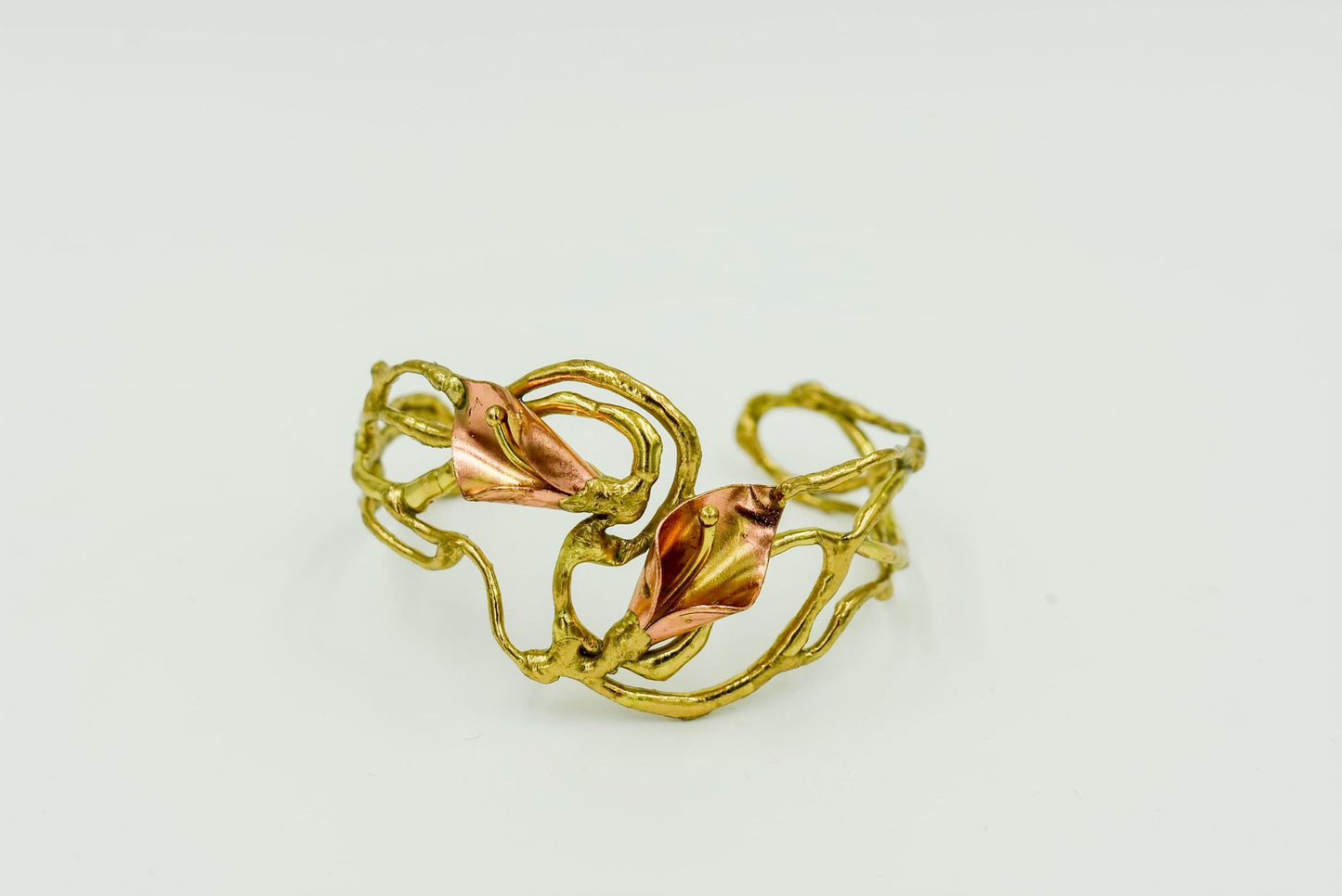 Adjustable Brass, bronze, and copper with silver Local Louisiana Artist Available in single large calla lily or small double calla lily. Comes in two designs large single calla lily or small double calla lily