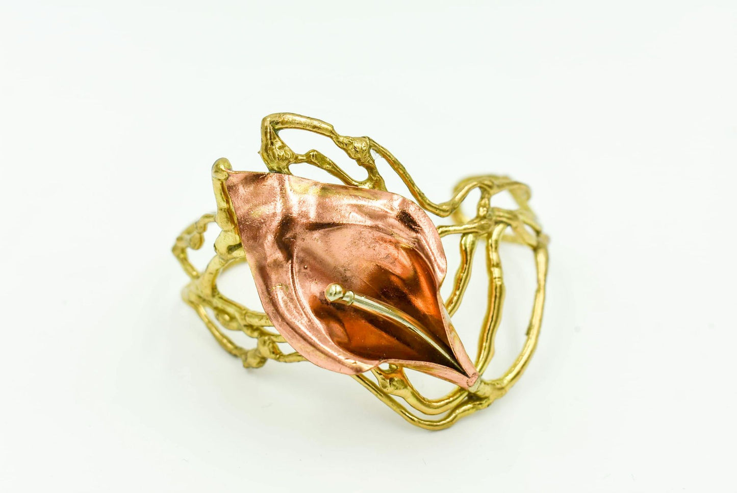 Adjustable Brass, bronze, and copper with silver Local Louisiana Artist Available in single large calla lily or small double calla lily. Comes in two designs large single calla lily or small double calla lily