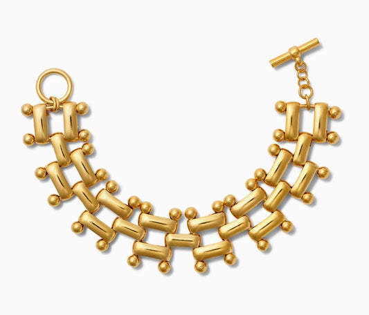 Get ready to add some flair to your wrist with this Epaulette Link Toggle Bracelet! The fluid links are polished with 14-karat gold over brass, giving off a touch of elegance. This bracelet is 3/4" wide and measures 7 1/2" end to end. The signature toggle and ring clasp by CC &amp; Co by Catherine Canino give it a unique touch. So go ahead, rock this quirky and fun bracelet with confidence!