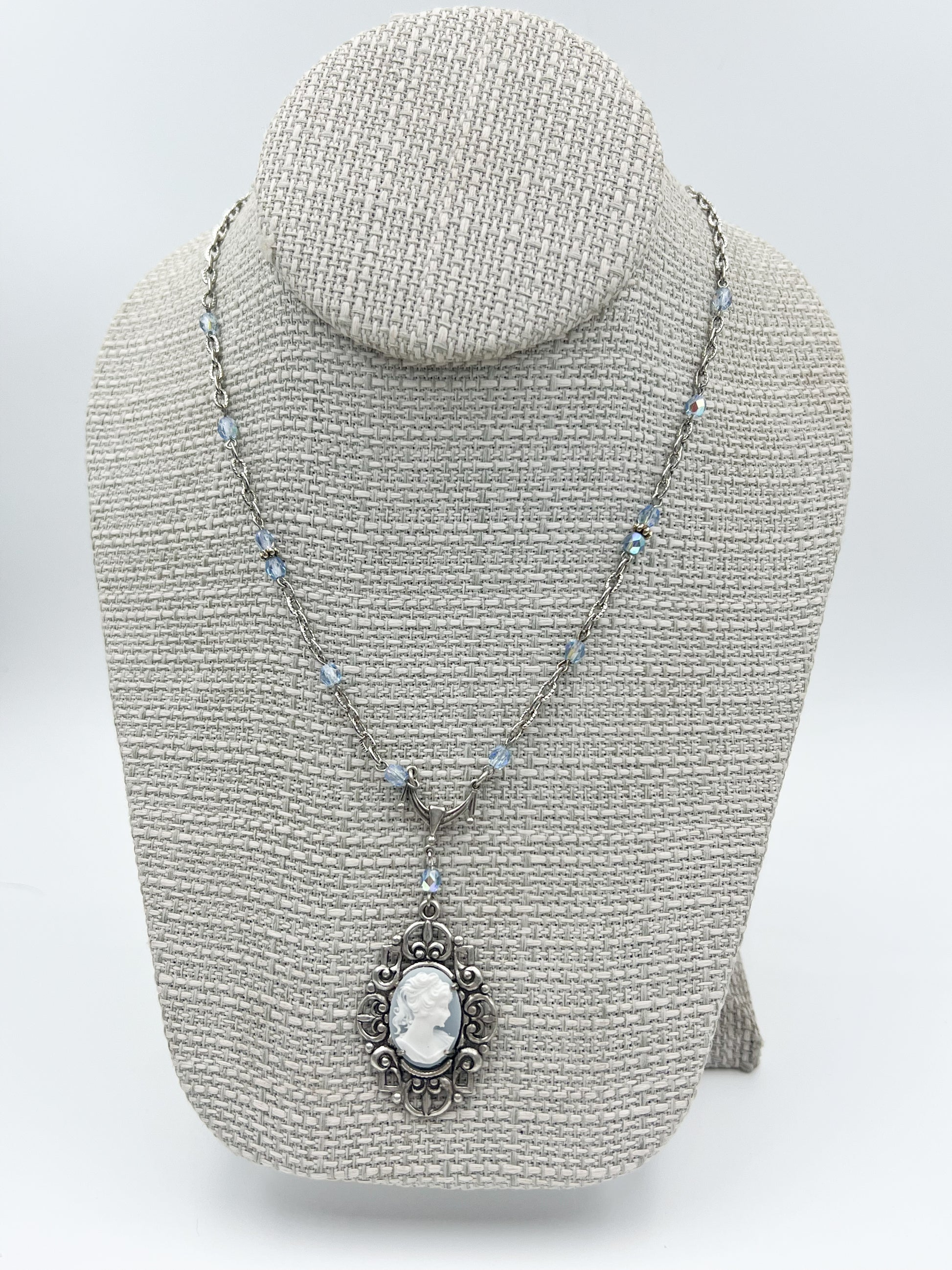 Necklace with a pendant on a gray bust against a white background