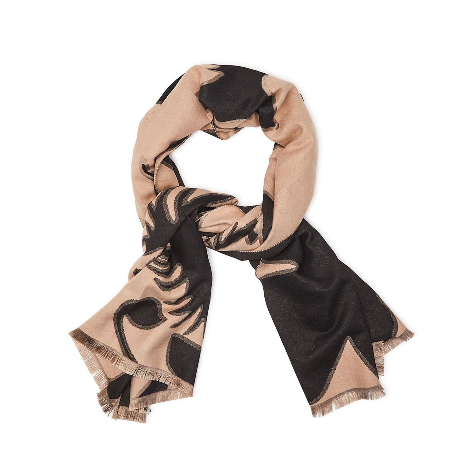 The versatile design of this shawl allows for endless styling possibilities. Drape it over your shoulders for a chic and effortless look or wrap it around your neck as a statement scarf. The abstract botanical print is both trendy and timeless, making it a great accessory to wear all year round.  Super soft viscose-polyester blend 70"L Reversible wear