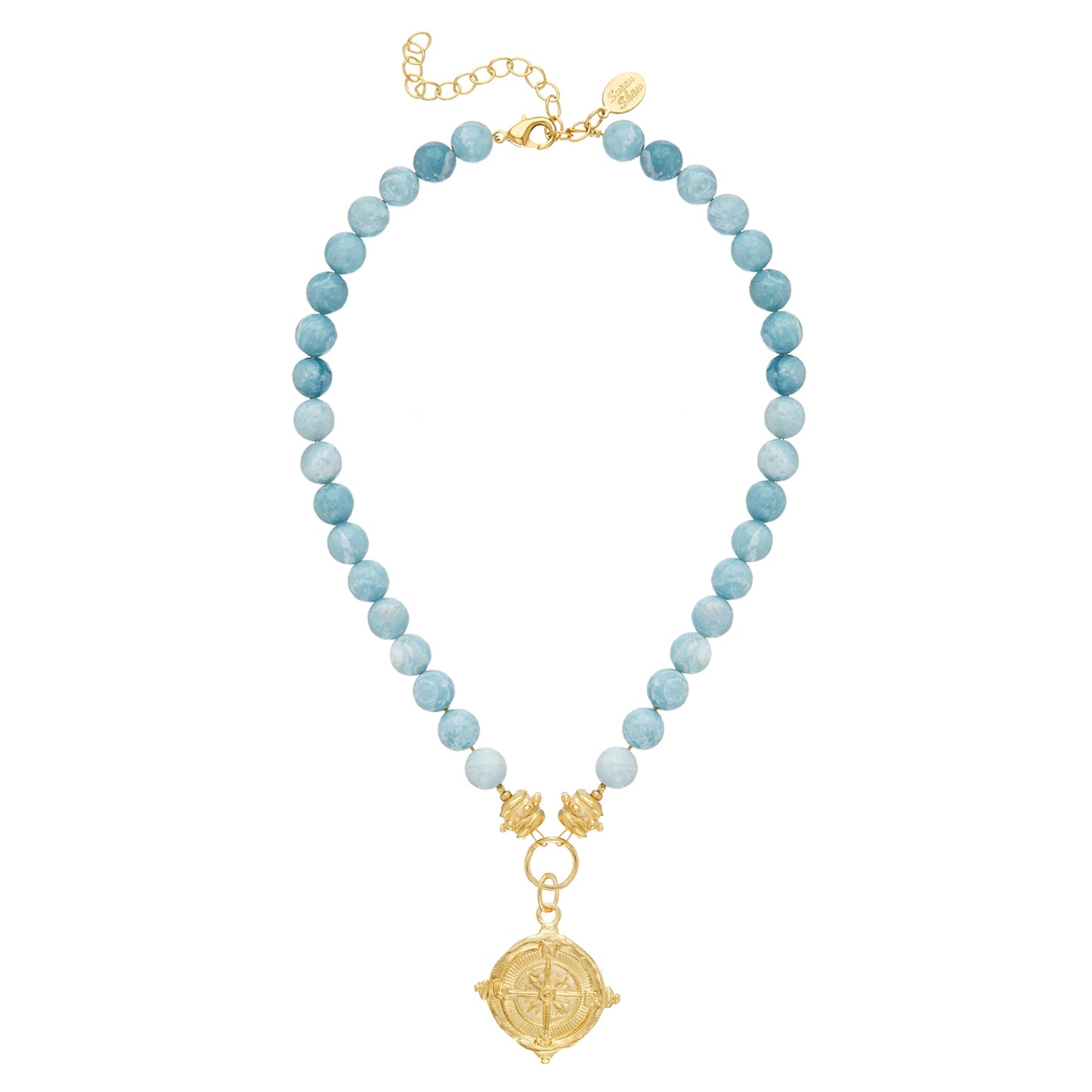 The versatile Blue Jasper Compass Necklace can accompany you from a day at the beach, to a baby shower, and all the way to the boardroom. Its delicate design features swirling soft blue Jasper beads and a gold compass pendant, adding a touch of boldness and femininity to any event. Created by Susan Shaw, the Nellie Necklace is playful yet polished, and comes with a 16" chain and a 3" extender.