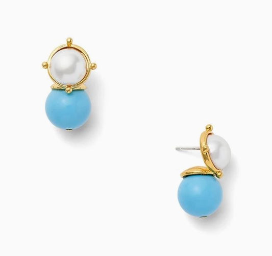 Add a touch of whimsy with these stunning Turquoise and Pearl Post Earrings from CC and Co by Catherine Canino! The 10mm white mother of pearl cabochon top is beautifully complemented by a 12mm turquoise, lacquered mother of pearl drop. The surgical steel post with large hypoallergenic rubber backing ensures a secure fit. Overall length measures 3/4" and features a polished 14 karat gold over brass finish.