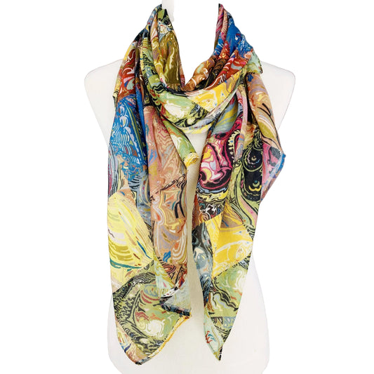 Colorful scarf with abstract design on a mannequin against a plain background