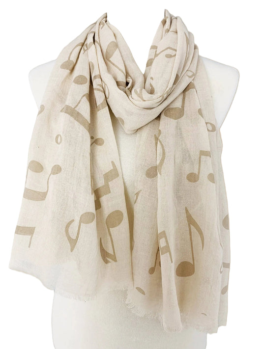 Beige scarf with music note pattern on a mannequin against a beige background