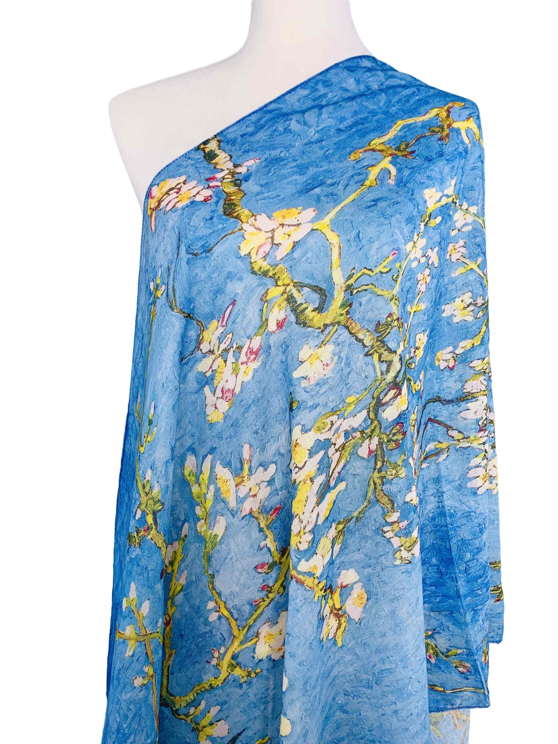 Blue scarf with floral design on a mannequin against a white background