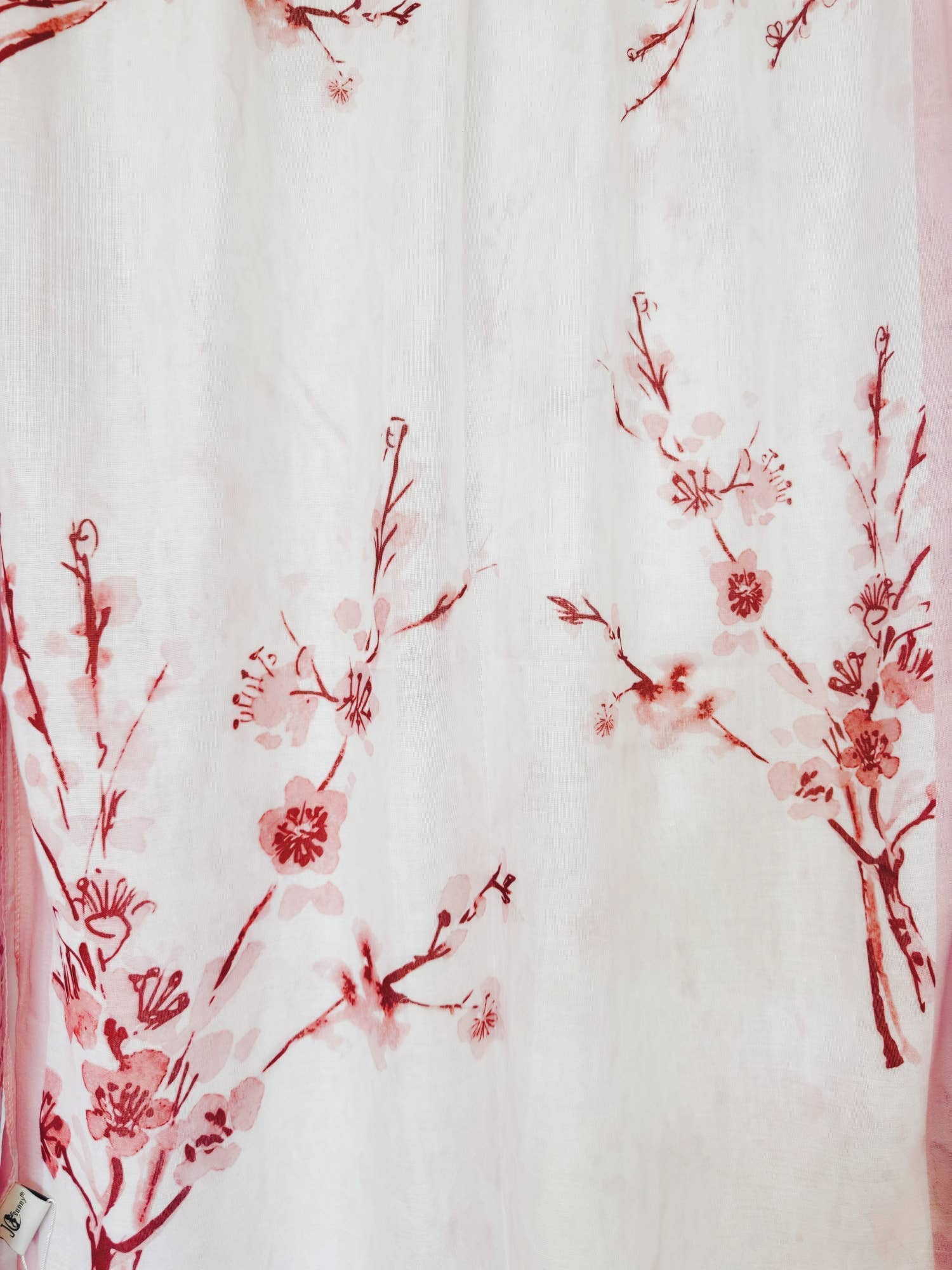 Red floral pattern on a white fabric background