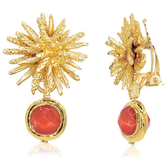 Sway and sparkle with our Coriandoli Clip-on Starburst Earrings in Coral! These charmingly offbeat earrings feature a signature starburst clip-on design adorned with playful faceted beads in a splash of vibrant color. Made with a pewter alloy base plated in 24-karat gold or sterling silver and measuring 1.5" long, these earrings are perfect for adding a touch of whimsy to any outfit. Simply clip them on and let the fun begin!