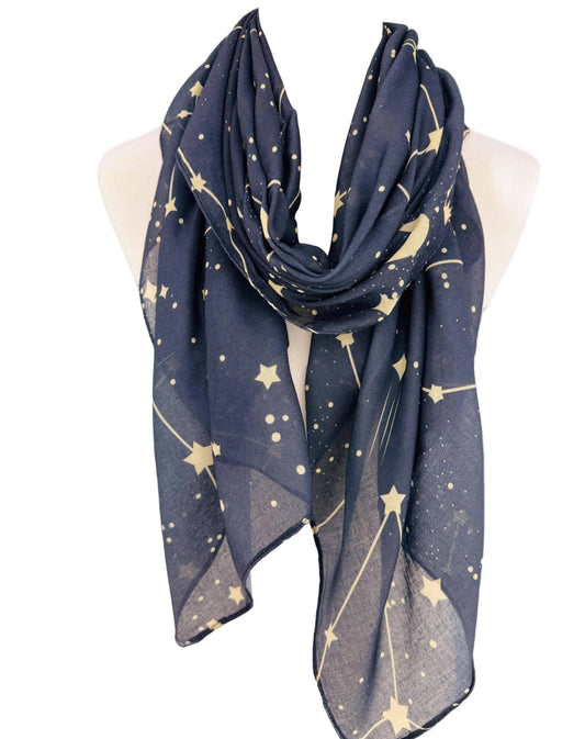 A navy blue scarf with a gold star and constellation pattern, draped on a cream-colored mannequin torso against a plain white background.