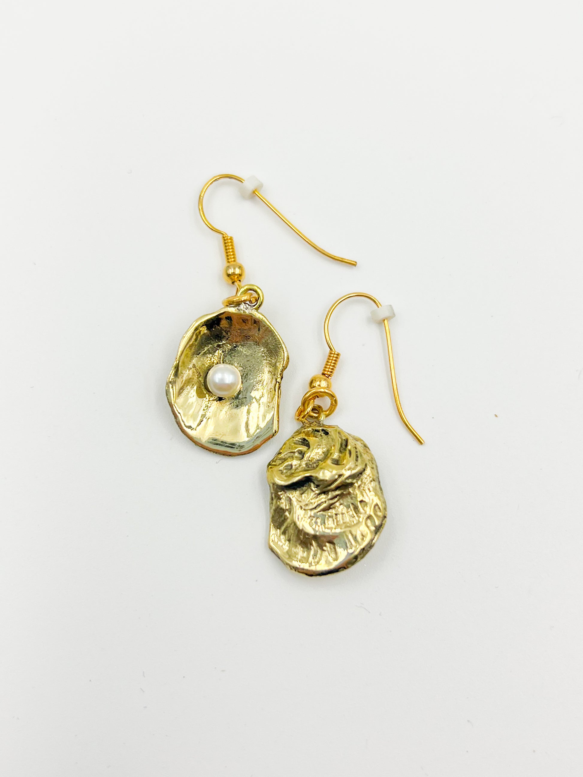 Gold earrings on a white background