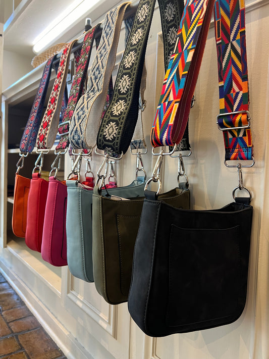 A Picture of how the Ashley Suede Crossbody Bags are displayed at the 1850 House Museum & Gift Shop Jackson Square NEw ORleans LA