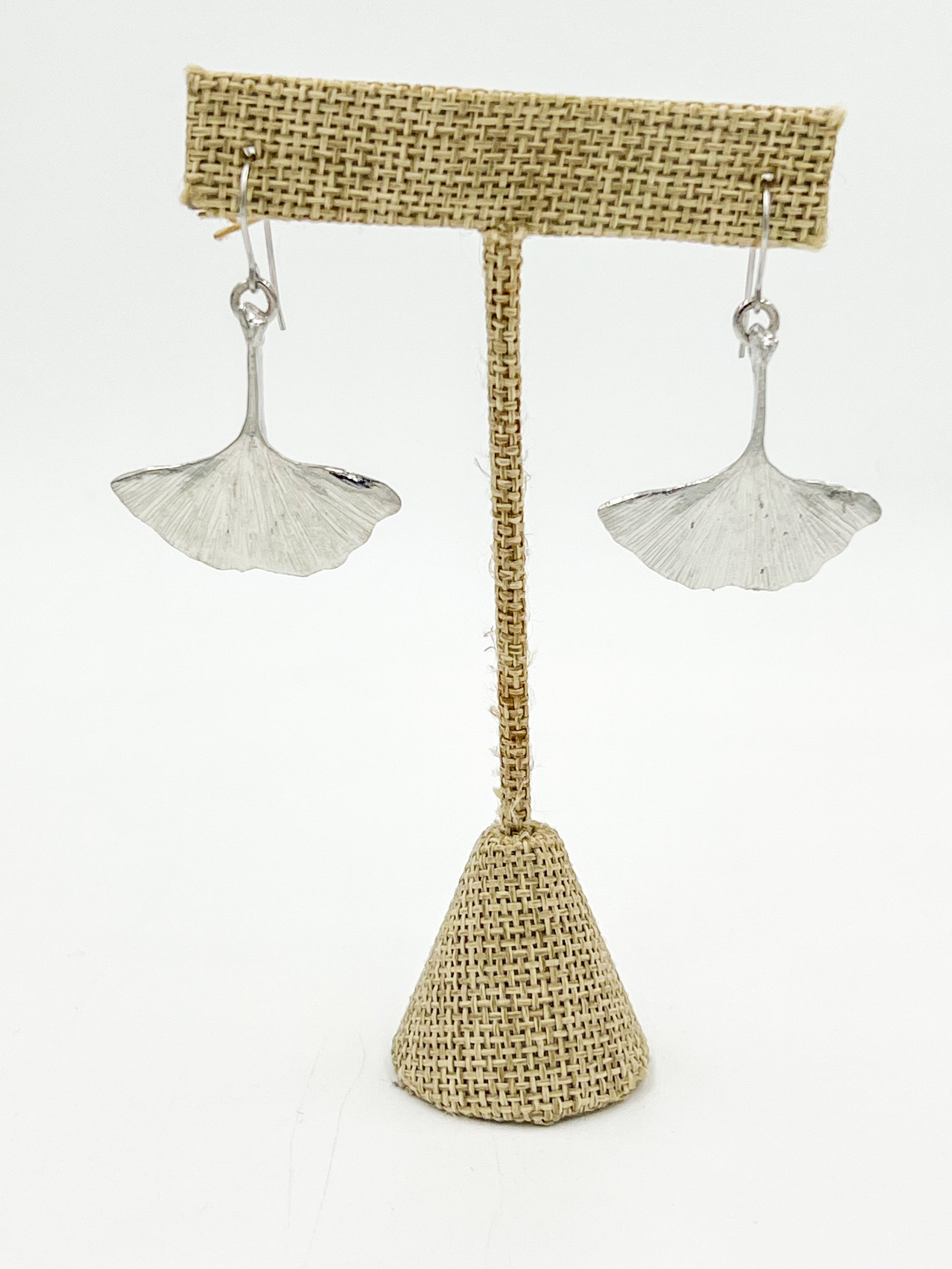 Add some natural charm to your wardrobe with our Ginkgo Wire Earrings! These earrings are crafted from highly polished pewter wire and feature the unique shape of the ginkgo leaf. Made with surgical steel, these earrings measure 1.25 inches for a comfortable fit. Get ready to leave a lasting impression with these one-of-a-kind earrings!