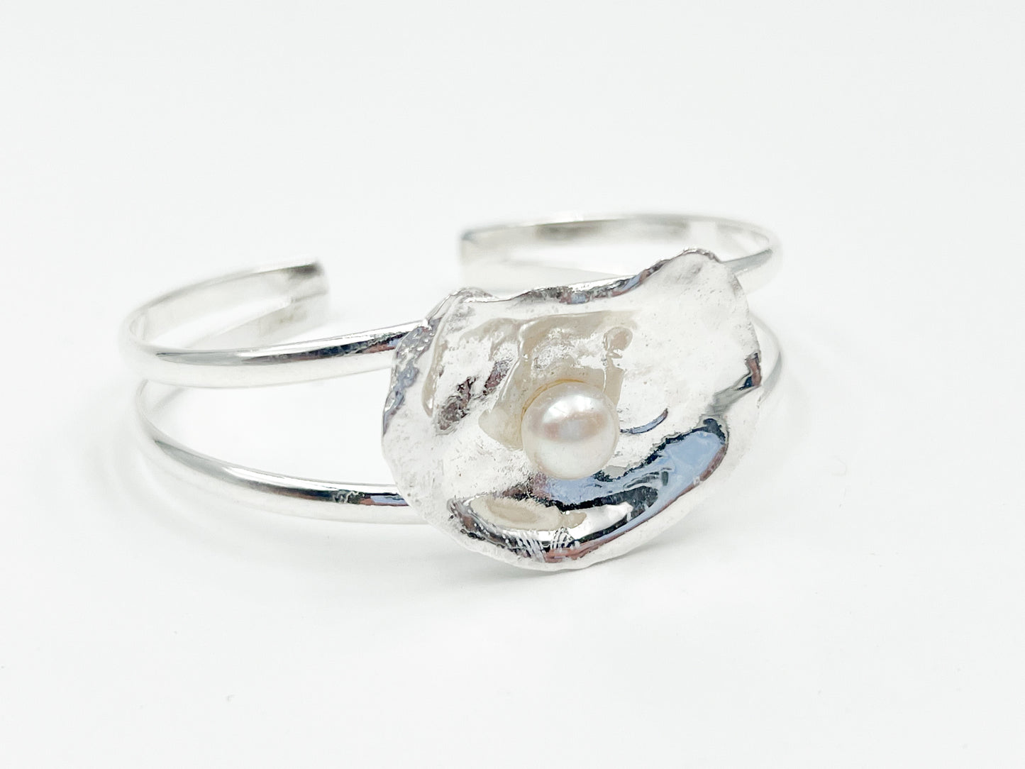 silver plated oyster bracelet on white background