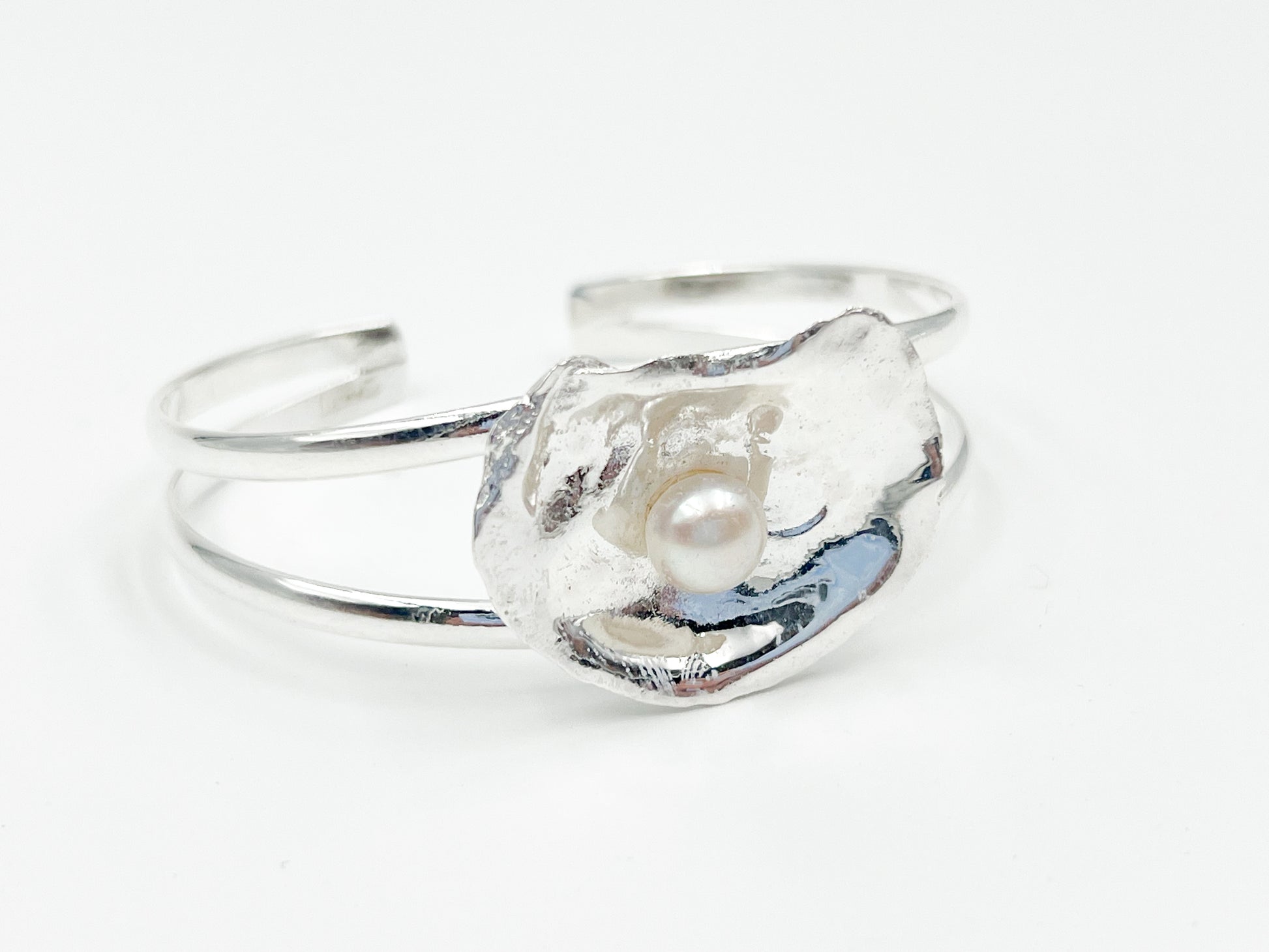 silver plated oyster bracelet on white background