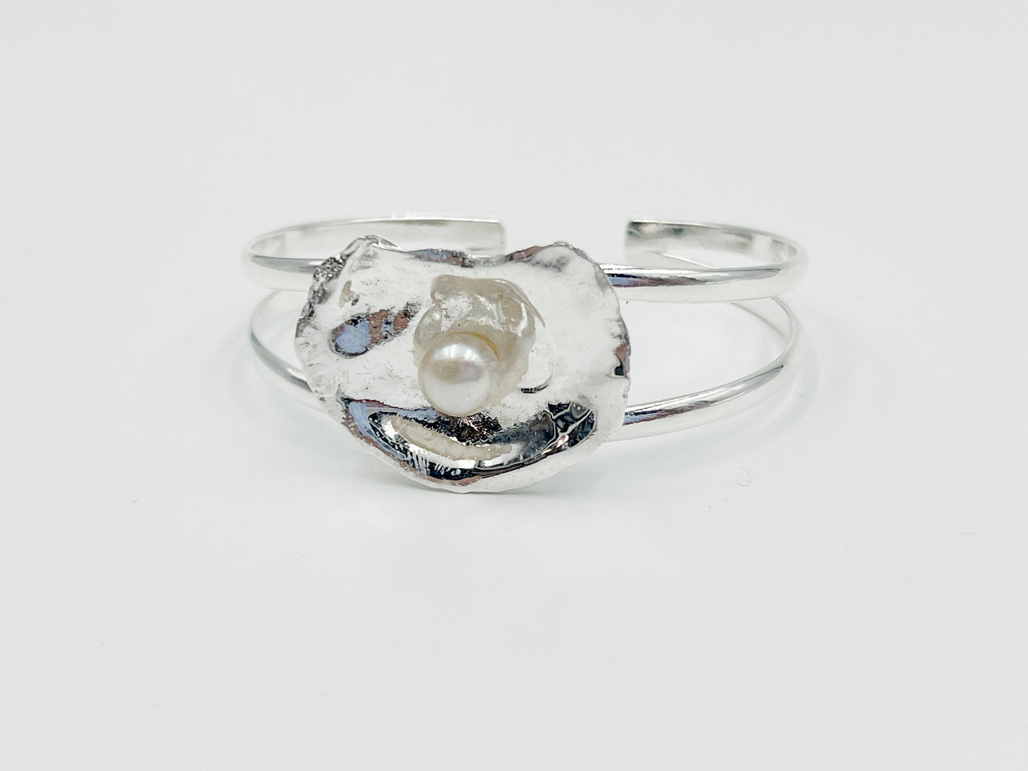 silver plated oyster bracelet on white background. 