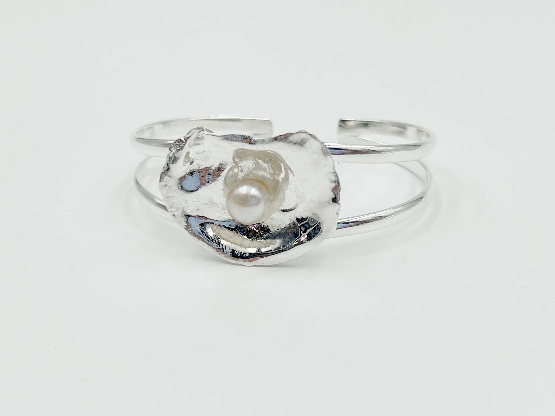 silver plated oyster bracelet on white background. 