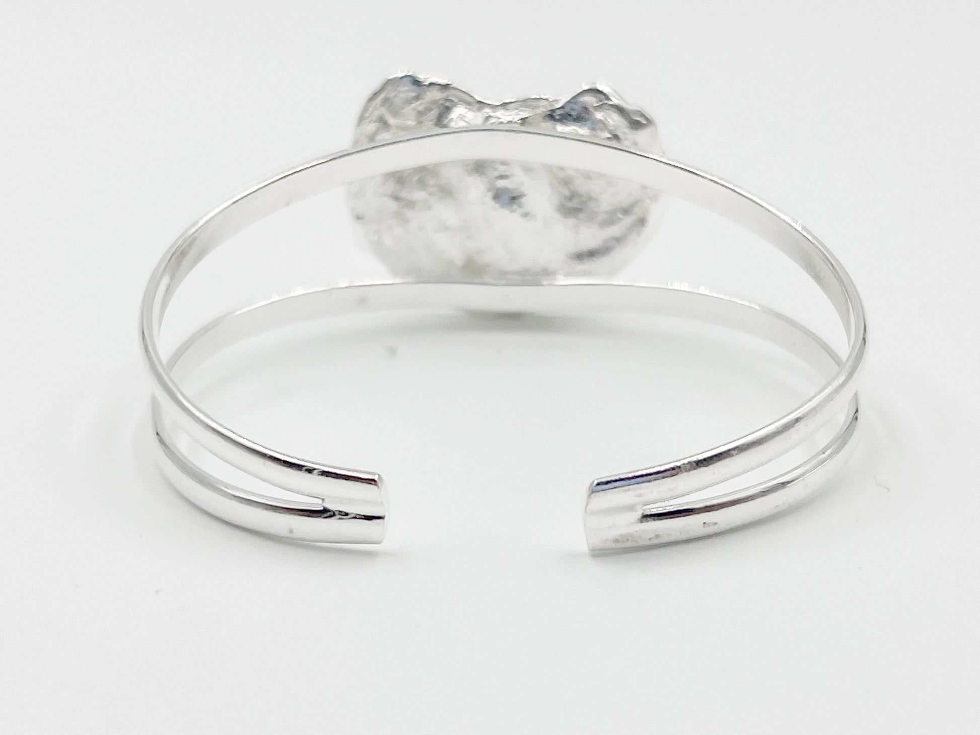 silver plated oyster bracelet on white background
