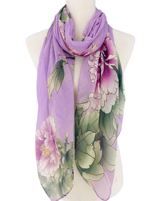 Floral scarf with purple and green colors on a mannequin against a white background