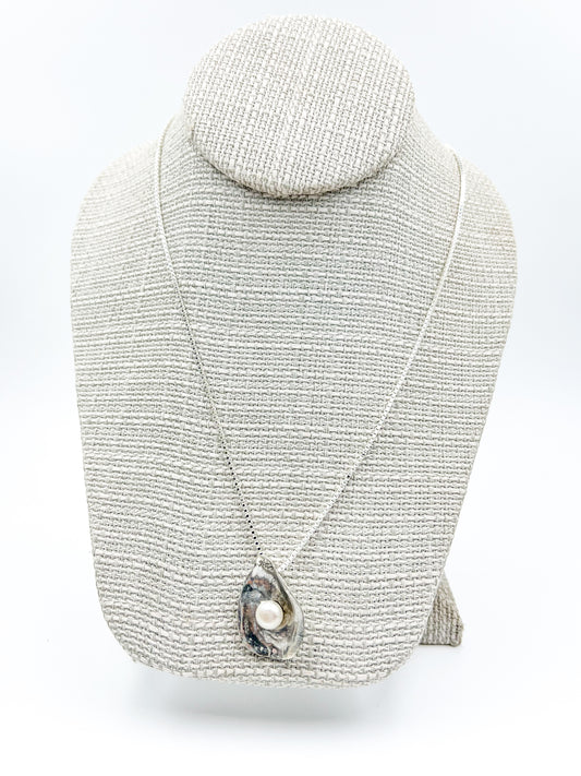 Dive into Lety G's beloved oyster collection with this stunning necklace, showcasing her signature oyster pendant cradling a luminous freshwater pearl. The 20" sterling silver box chain offers the perfect length for everyday wear and layering. Mix and match with the viral TikTok oyster bracelet and petite earrings to craft your own pearl-inspired jewelry story.