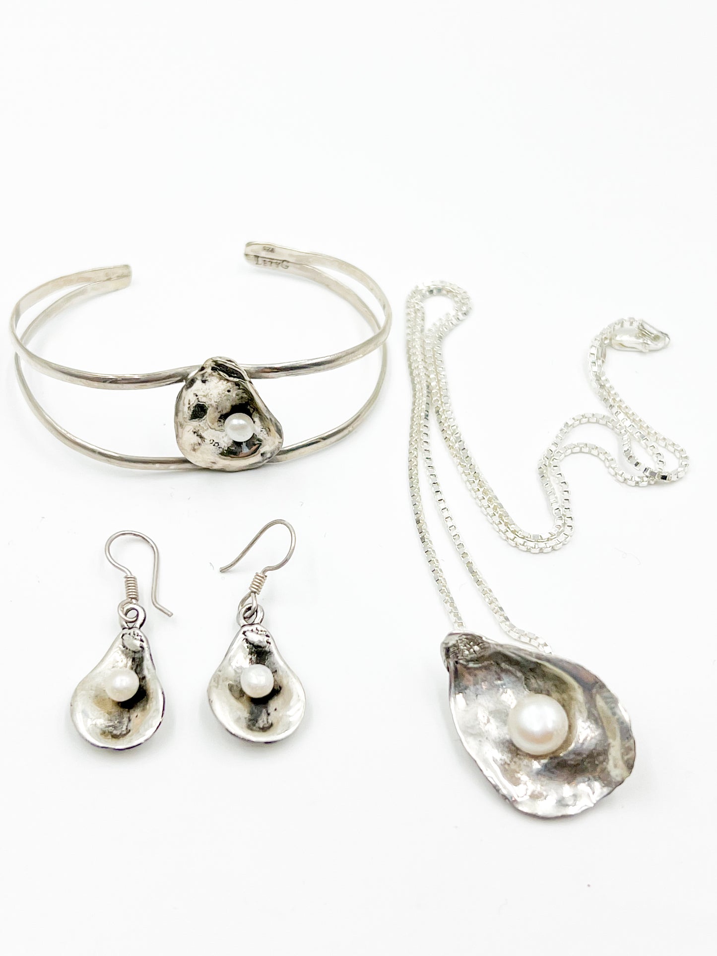 Dive into Lety G's beloved oyster collection with this stunning necklace, showcasing her signature oyster pendant cradling a luminous freshwater pearl. The 20" sterling silver box chain offers the perfect length for everyday wear and layering. Mix and match with the viral TikTok oyster bracelet and petite earrings to craft your own pearl-inspired jewelry story.