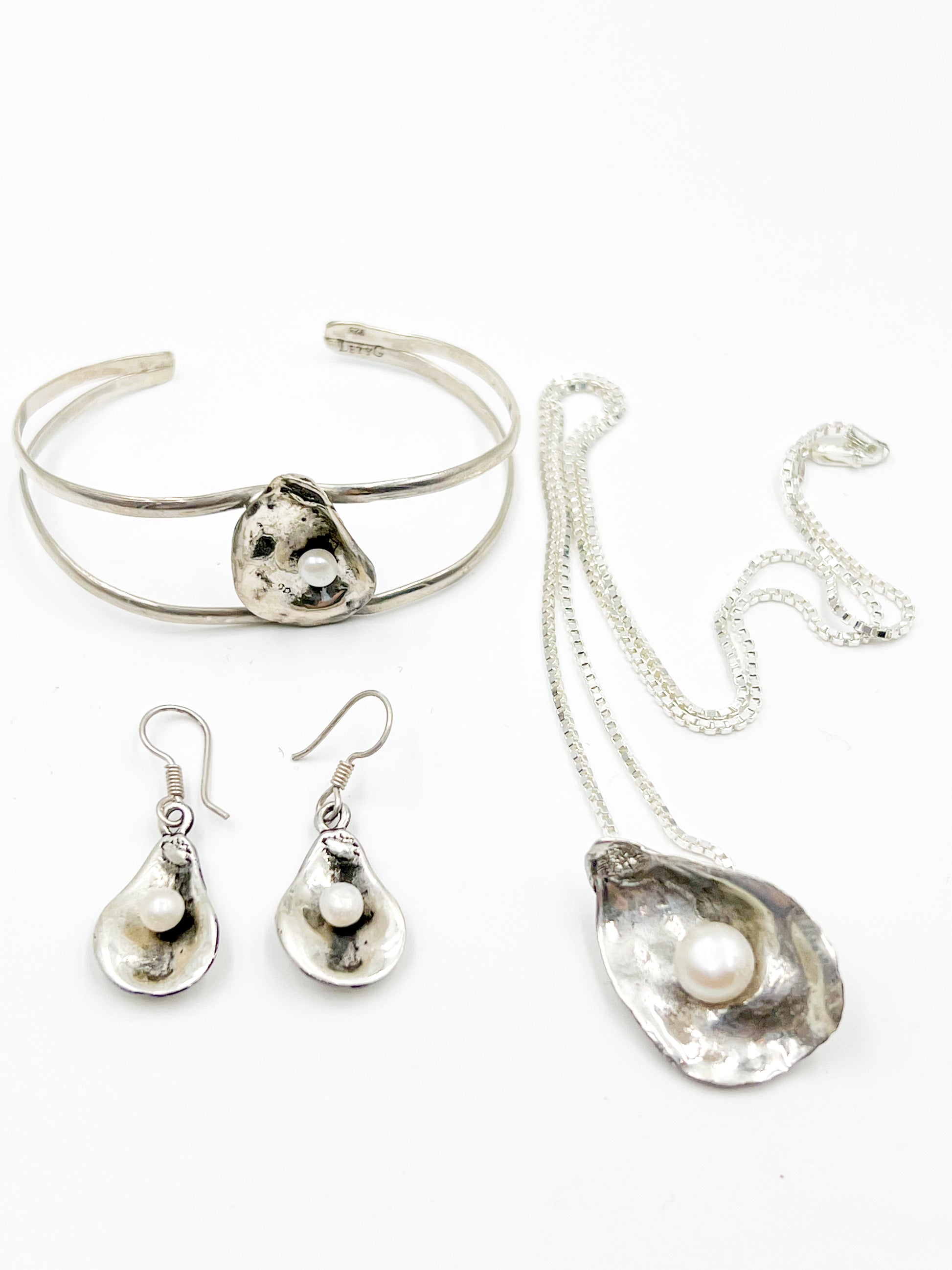 Dive into Lety G's beloved oyster collection with this stunning necklace, showcasing her signature oyster pendant cradling a luminous freshwater pearl. The 20" sterling silver box chain offers the perfect length for everyday wear and layering. Mix and match with the viral TikTok oyster bracelet and petite earrings to craft your own pearl-inspired jewelry story.