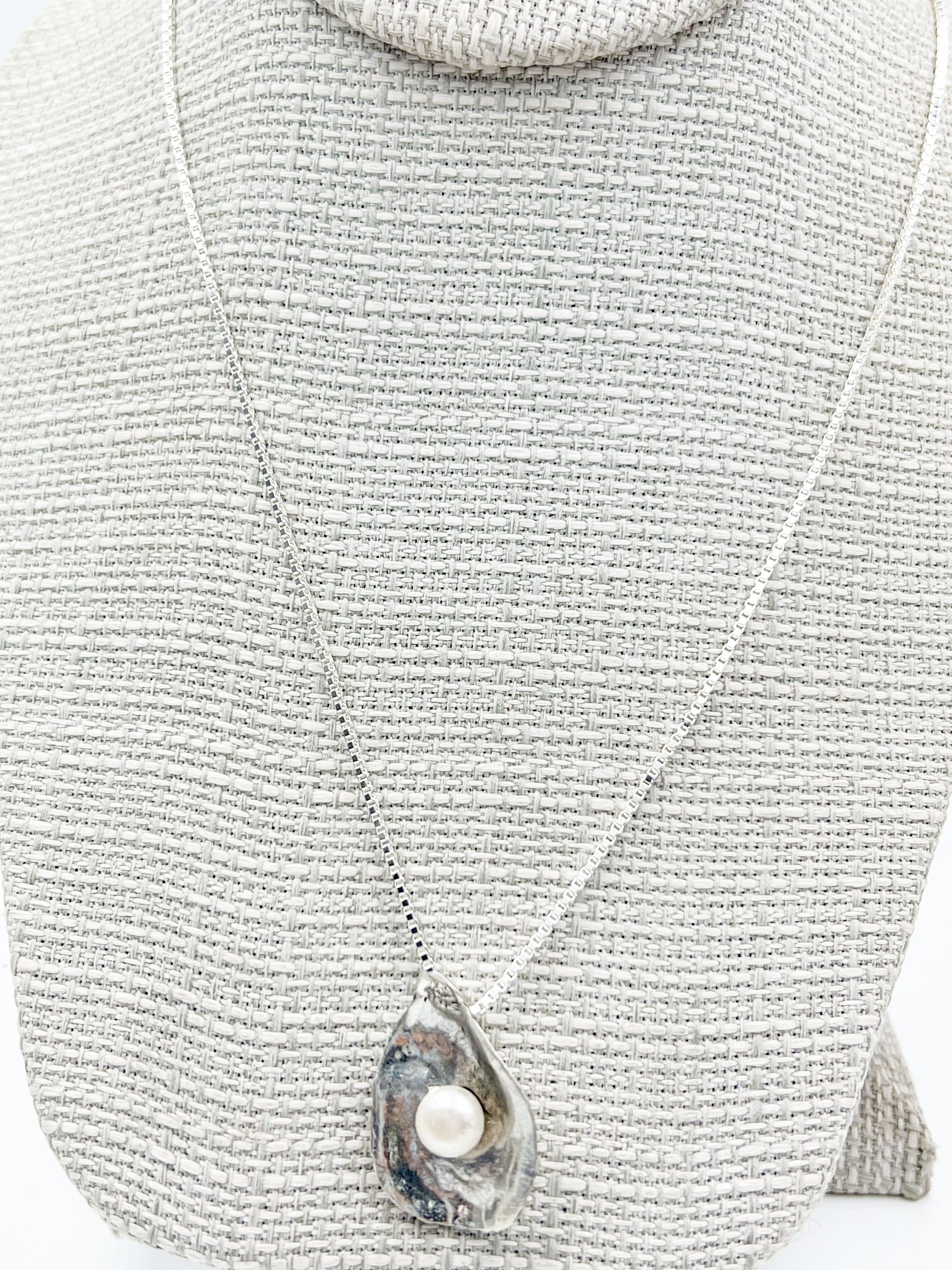 Dive into Lety G's beloved oyster collection with this stunning necklace, showcasing her signature oyster pendant cradling a luminous freshwater pearl. The 20" sterling silver box chain offers the perfect length for everyday wear and layering. Mix and match with the viral TikTok oyster bracelet and petite earrings to craft your own pearl-inspired jewelry story.