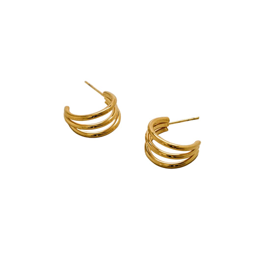 Pair of gold hoop earrings on a light gray background