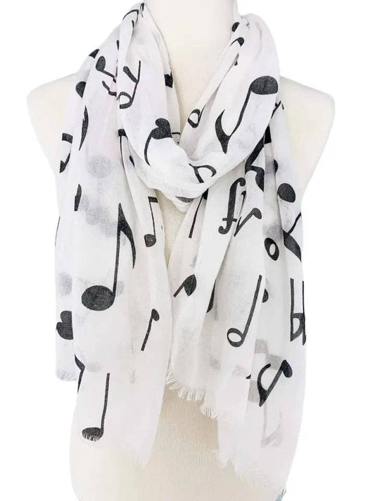 White scarf with black musical note pattern on a mannequin
