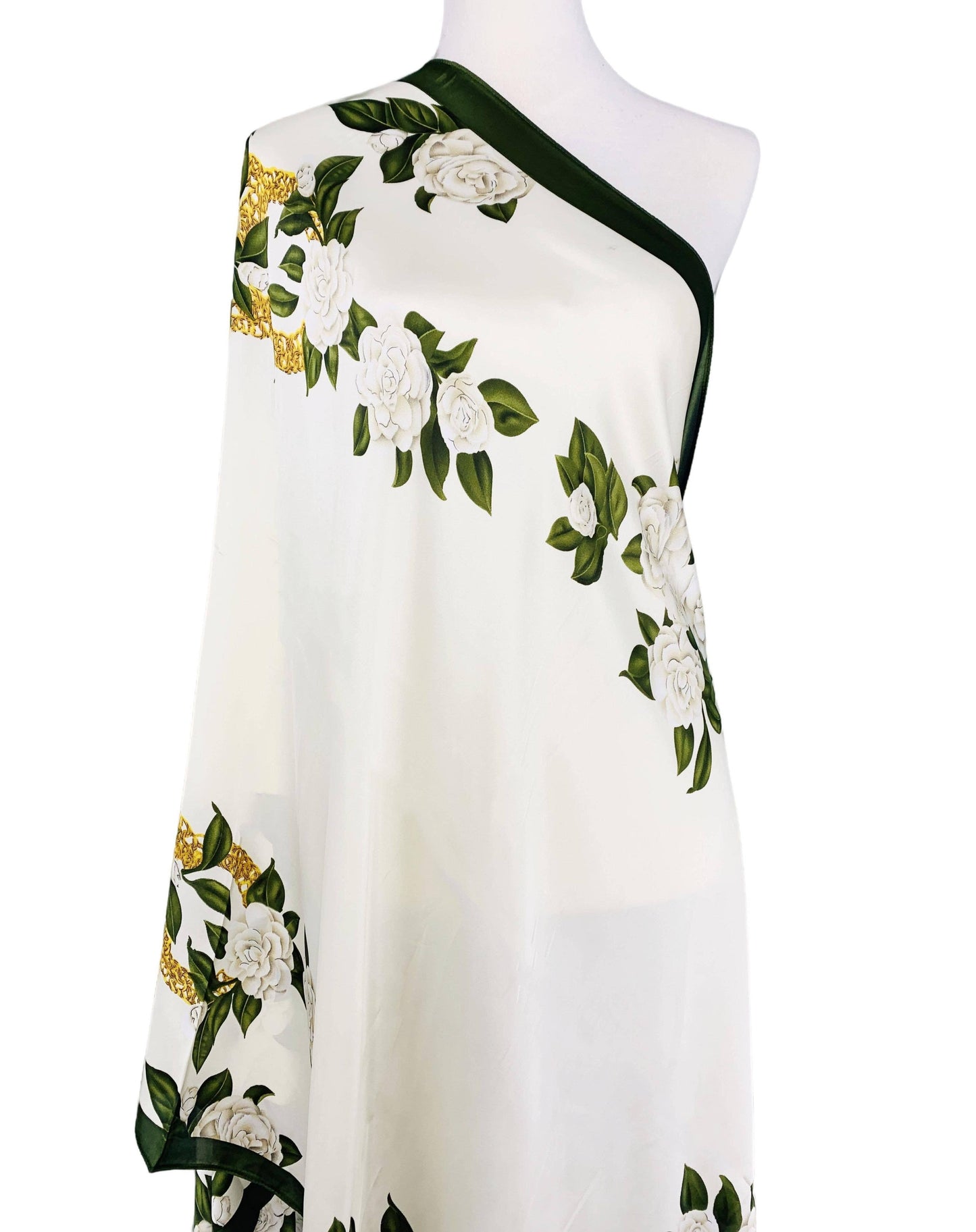 White dress with floral patterns on a mannequin against a white background