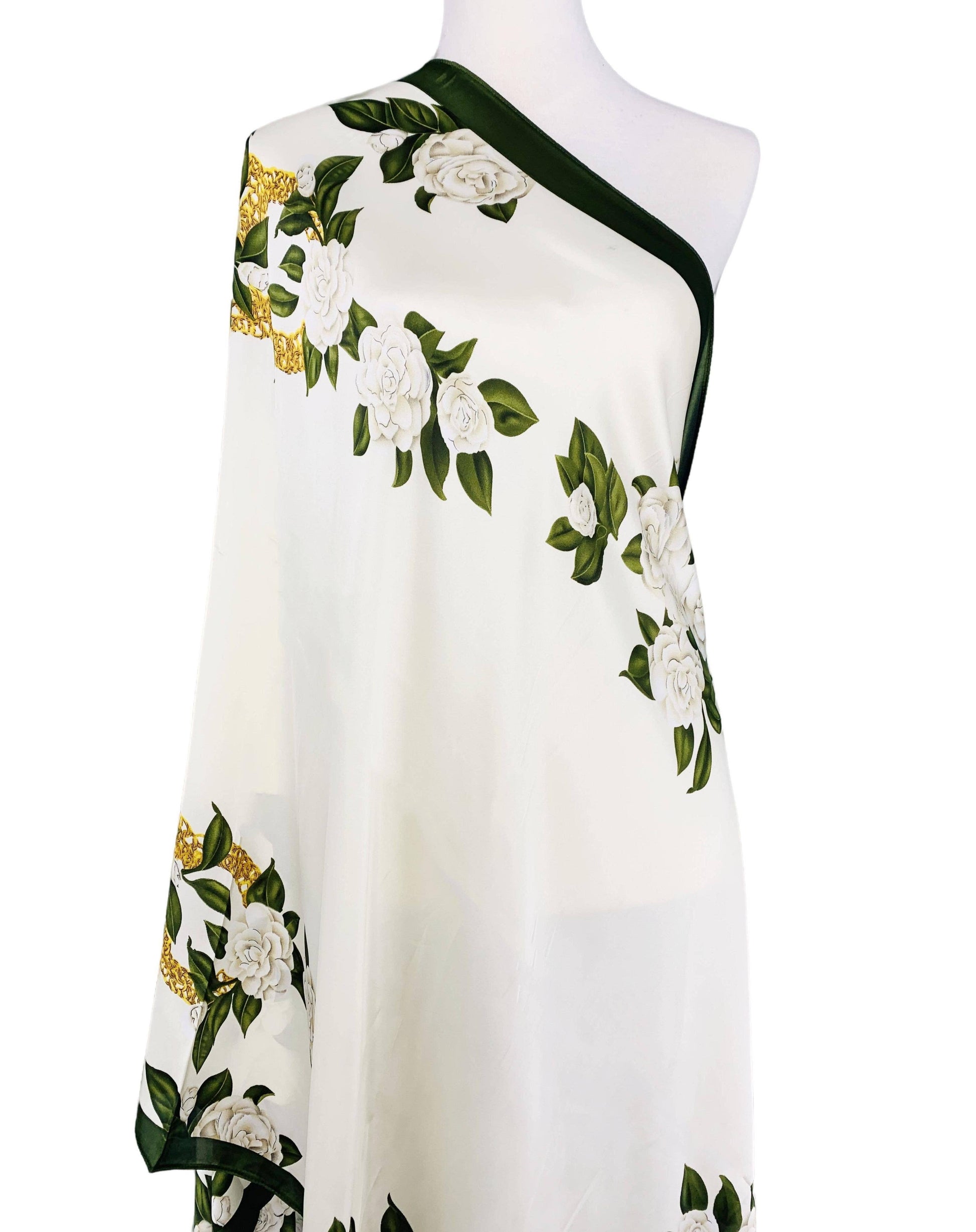 White dress with floral patterns on a mannequin against a white background
