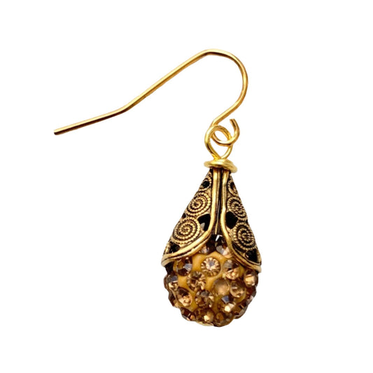 This is a classic earring style that never leaves the Lenora Dame collection. Sparkling rhinestone paves cupped into high-quality gold plated brass filigree bead caps with detailed scrolled etching give these earrings a high-end vintage earring look. Perfect gift or treat yourself to this earring that's perfect to add a little bling and sparkle to casual or special occasion outfits. 1" drop. Make it a set with the matching Filigree Bead Cap Rhinestone Choker. Handmade in the USA.