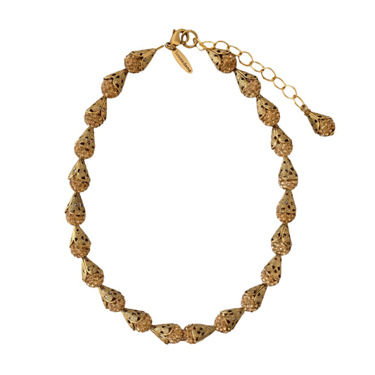 Little Black Dress Approved! Inspired by the glamorous days of the Great Gatsby style of the roaring 20's art deco movement we bring to you this sparkling charm necklace! Shimmering rhinestone clay pave beads catch the light for an attention-grabbing style encased in our signature brass filigree bead cap. Necklace measures 16-inches with 3-inch extension, but if you need more length please let us know. This necklace is designed to be worn as a choker but we understand that not all necks are the same.