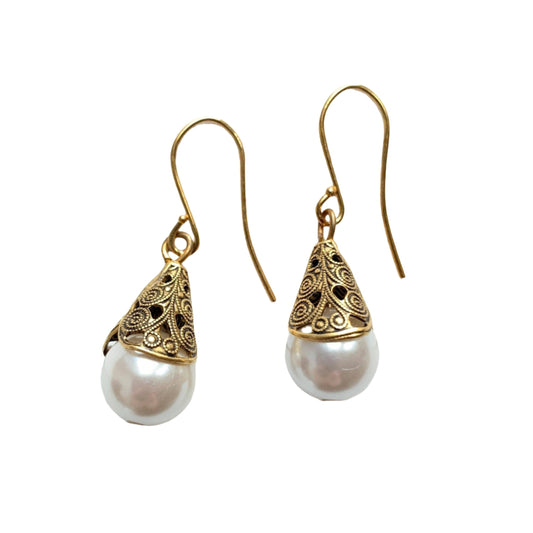 This is a classic minimalist earring style that never leaves the Lenora Dame collection. Sophisticated pearls cupped into high-quality gold plated brass filigree bead caps with detailed scrolled etching give these earrings a high-end vintage inspired earring look. These earrings have a dainty total drop length of 1-inch. Perfect gift or treat yourself to this earring that's perfect to add a little bling and sparkle to casual or special occasion outfits. Make it a set with the Filigree Bead Cap Necklace.