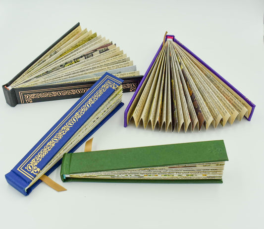 A book fan for lovers of lovely things! Bound in a quality buckram cloth and embellished with gold foil filigree detail, inside you will discover a patchwork of beautiful old book text and period illustrations. 6.3" X 0.5" X 1.1".     Available in the following colors: Red, Rose Gold, Blue, Purple, and Green
